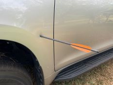Image of crossbow arrow embedded in car body