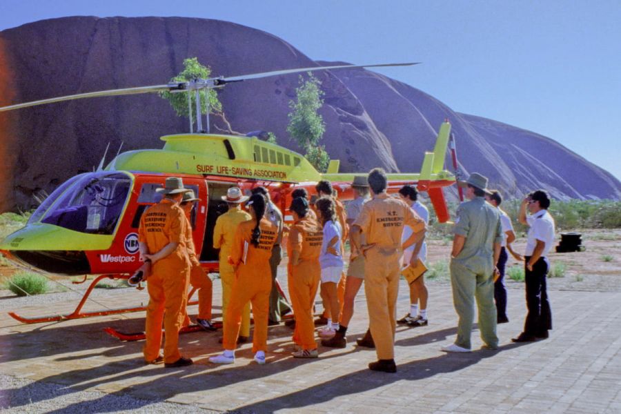 NTES members with helicopter in background